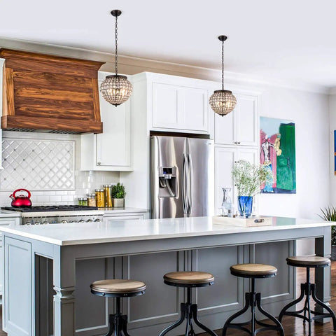 14 inch Crystal Pendant Light, 2-Light Antique Bronze Small Chandelier hanging over a kitchen island in a modern setting.