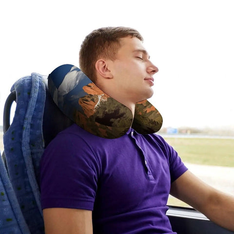 Man using Pikes Peak Colorado Travel Pillow U Shaped Neck Support for Long Haul Flights and Office Naps on bus seat.