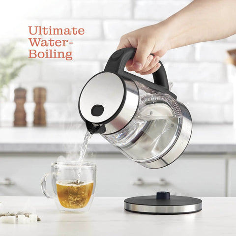 Fast Boil Electric Kettle For Coffee And Tea 1.7L Water Boiler 1500W Borosilicate Glass pouring water into a cup on a kitchen counter.
