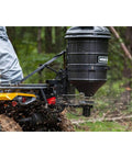 ATV Spreader With Manual Feed Gate For Seed Or Fertilizer, 100 Pound Hopper, Heavy Duty 12 Volt Motor in action on rough terrain.