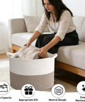 Woman using 65L Large Woven Cotton Rope Laundry Basket With Reinforced Handles No Snag Edges Rugged Hamper in living room