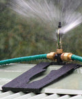 Real Deal Rooftop Sprinkler Offering 360 Degree Rotating Spray Pattern For Lawn And Garden Irrigation No Sweat Setup close-up of metal base and spray
