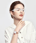 Woman wearing wraparound anti-fog safety glasses with blue light blocking lenses, pink frame, for cycling and work protection.