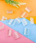 12 Pack Clear Acrylic Hinges Self Adhesive Transparent Piano Strips For Cabinet And Aquarium Lids Straight Up Durable Furniture Hardware No Sweat DIY Setup Smooth Finish 35X30MM on colorful background.
