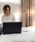 Dimmable Floor Lamp For Bedroom And Living Room Decor With Modern LED Tall Tree Design In Brass Finish beside a woman using a laptop