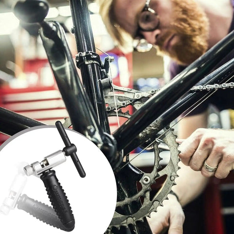 Bike Chain Breaker Tool Universal for 7 8 9 10 11 Speed Chains Link Removal in use on a road bike by a mechanic