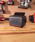 20V Brushless Power Tool Combo Kit With Drill Driver Reciprocating Saw Oscillating Multi Tool Bluetooth Speaker on workbench.
