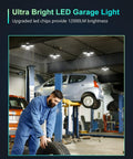 Mechanic working under 120W LED Garage Light 12000LM 6000K With 3 Adjustable Panels in a brightly lit auto workshop