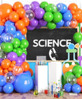 Epic Balloon Arch Kit 122 Pcs Colorful Balloon Garland Set In Purple Dark Blue Green Orange Transparent For Boys Science Birthday Party Lab Scientist Classroom Decorations with colorful balloons framing a science-themed backdrop.