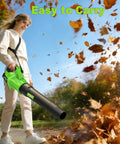 User holding Beast Cordless Leaf Blower With Upgraded 1200W Brushless Motor, clearing autumn leaves, sunny day