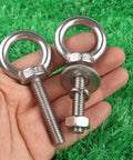 Stainless Steel Eyebolts With Nut Washers 3/8 Inch By 2 Inch M10x50mm Durable Rust Resistant Outdoor Hanging Eye Bolts For Swing Chairs Hammocks Garden Balcony Lights 4 Pack, held in hand on green grass background