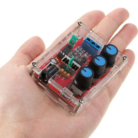 Hand holding XR2206 Precise Function Signal Generator Module Pro Grade DIY Kit in clear case, showing controls and connections.