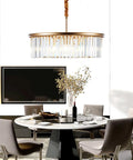 23 Inch 8 Light Modern Crystal Chandelier With Dual Gold Rings hanging over a dining table, adding elegance to the room.