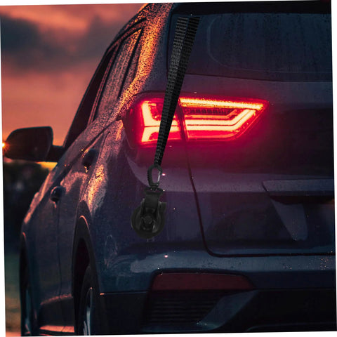 Side view of a car with a Heavy Duty Cup Hooks 4 Pack With Suction Anchors For Camping And Outdoor Travel attached to rear window