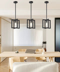 37.5 Inch Black Industrial Pendant Chandelier For Dining Room And Kitchen Island, 6 Light E26 Fixture hanging over table.