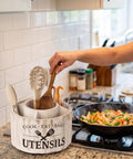 Extra Large 10 Inch Kitchen Utensil Holder With Slick 360 Degree Lazy Susan Spin displaying spatulas and a wooden spoon.
