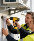 Two workers using a heavy duty drywall dust collector for saw drilling tasks while installing an air conditioning unit.