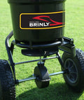 Heavy-Duty Push Spreader With Side Deflector Kit And Hopper Grate For Lawn Care, 50 Lb Capacity Handles Fertilizer, Grass Seed, Or Ice Melt, Flat Black Finish For Easy Storage And Long Lasting Rust-Proof Build on lawn