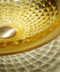 USZWBY Bathroom Vessel Sink Vanity Tempered Glass Vessel Bowl Sink Round Luxury Countertop Sink Bowl Above Counter Sink Art Basin with Waterfall Faucet Pop Up Drain in golden color with textured surface.