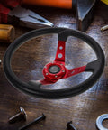 14 Inch Racing Steering Wheel for Cars and Golf Carts PU Drifting Wheel, red with horn button, on wooden surface with tools.