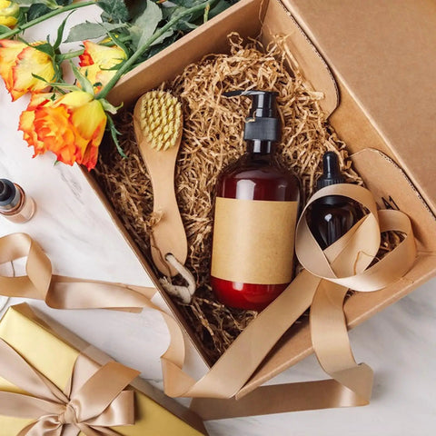 Gift box with 2 Lb Kraft Crinkle Paper Filler Brown Shredded Paper, bottles, brush, ribbon, and flowers