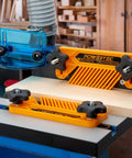Heavy Hitter Miter Slot Hardware Kit With Rock Solid Five Star Knobs And Dual Aluminum Star Bars Killer Router Table Featherboards in use on a wooden workpiece.