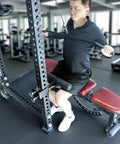Man using upgrade hamstring curl sit up bar attachments for power racks with pin rod and 3 adjustable holes fits 2x2, 2.37x2.37, 3x3 uprights.