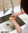 Person peeling vegetables over sink with Extended Garbage Disposal Flange Basket Strainer Stopper in brushed 304 stainless steel.