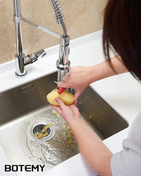 Person peeling vegetables over sink with Extended Garbage Disposal Flange Basket Strainer Stopper in brushed 304 stainless steel.