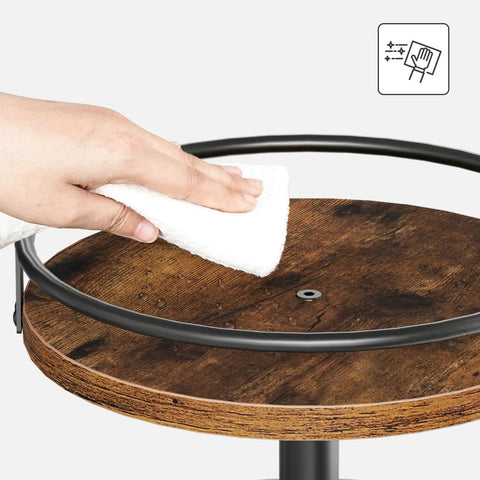 Hand cleaning rustic brown tier of 3-Tier Lazy Susan Organizer With Rotating Turntable Spice Rack, dark metal border visible.