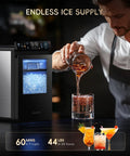 Top Shelf Nugget Ice Maker Countertop Unit cranks out 44 pounds daily, dispensing chewable ice into a glass.