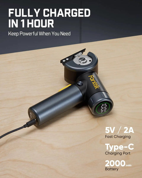 Fanttik C8 Nano Cordless Box Cutter charging with USB Type-C port and LED display on wooden surface.