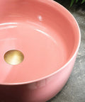 Top Shelf 15.7 Inch Round Pink Ceramic Vessel Bathroom Sink Over Counter Vanity Basin With Super Easy Pop Up Waste Kit Slick High Gloss Glaze Hits Different For Any Modern Home Space, featuring a glossy interior and a brass drain hole.