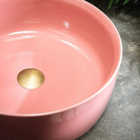 Top Shelf 15.7 Inch Round Pink Ceramic Vessel Bathroom Sink Over Counter Vanity Basin With Super Easy Pop Up Waste Kit Slick High Gloss Glaze Hits Different For Any Modern Home Space, featuring a glossy interior and a brass drain hole.