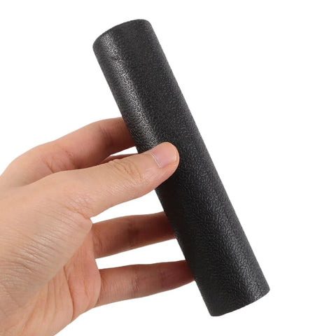Hand holding black plastic Ergonomic Lifting Handle Covers For Dumbbells And Barbells Non Slip Grips