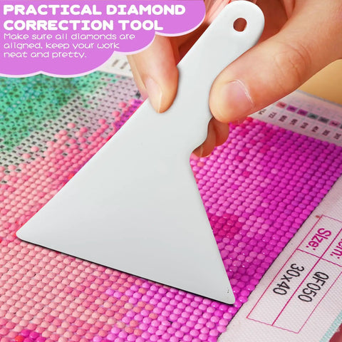 Hand using diamond correction tool from DIY Diamond Painting Tools And Accessories Kit 45 Piece Sweet Set For Kids And Adults.