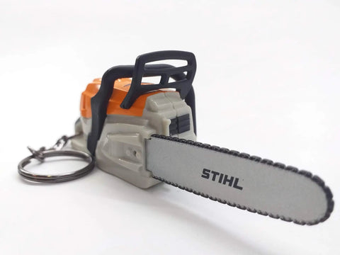 Battery Operated Chainsaw Keyring With Realistic Sound Effects, Orange Mini Tool Charm with silver chain attached.