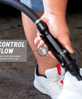 Hand holding nozzle control for Badass Electric Drum Pump With Telescopic Suction Hose for adjusting flow rate during transfer.