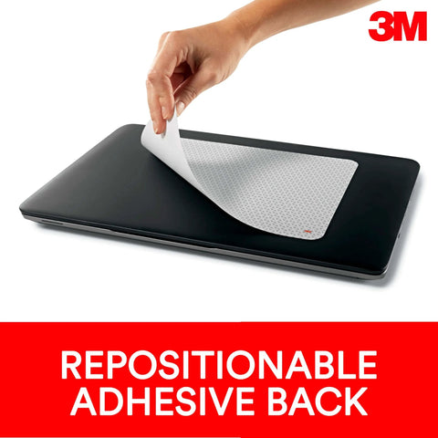 Hand peeling the Precise Mouse Pad with Repositionable Adhesive Back for Optical Mice at High Speeds on laptop surface.