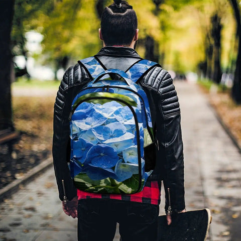 Back view of person wearing spacious unisex backpack with blue hydrangea print for summer garden vibe, durable polyester daypack.
