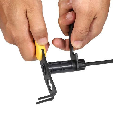 Hands using Universal MC4 Disconnect Tool 4in1 Solar PV Connector Wrench on black solar cable for secure installations
