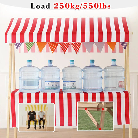 Built Tough Wood Roll Out Food Cart On Wheels With No Sweat Assembly For Street Vendors And Farmers Markets Mobile Market Stall Display Rack For Craft Shows And Weekend Hustle Stands Light Coffee Wood with red and white striped canopy.