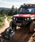 3 In 1 Electric Hoist Winch 1100 Lb Capacity 1500W Portable Crane pulling a red off-road vehicle on a dirt path