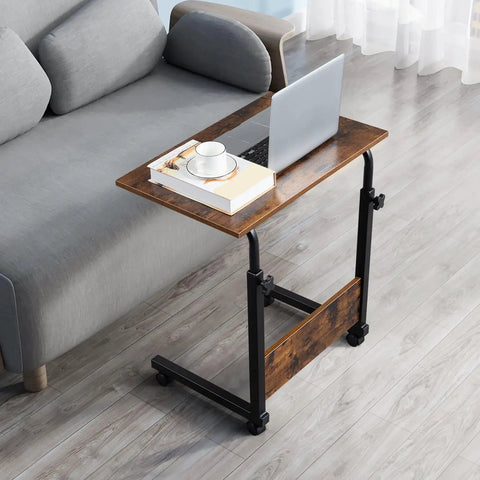 Rock Solid Height Adjustable Computer Desk With Smooth Rollin Casters For Easy Repositioning And Firm Lockdown Heavy Duty Steel Top crafted as a compact workstation beside a sofa.