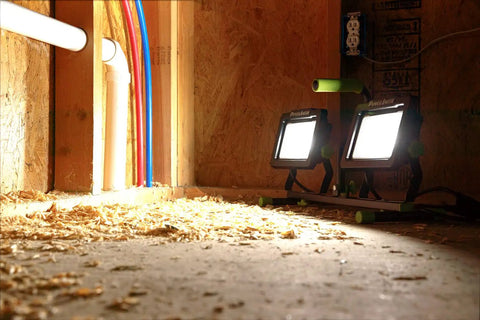 Dual 14,000 Lumen LED Work Light illuminating a construction area, part of the 60 Inch Telescoping Tripod Stand setup.