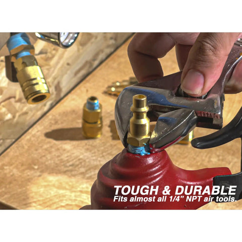 Close-up of a hand tightening Brass 1/4 Inch NPT Male Air Couplers Set, Six Piece Industrial M Style Quick Connect Fittings on red tool