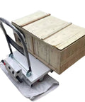 Heavy Duty Hydraulic Forklift Cart With 4-Wheel Electric Scissor Lift Platform carrying a wooden freight box for warehouse lifting.