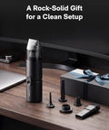 Cordless Handheld Vacuum Cleaner Four In One Air Duster And Desk Vacuum with attachments on desk near gift box.