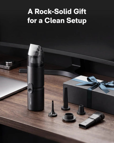 Cordless Handheld Vacuum Cleaner Four In One Air Duster And Desk Vacuum with attachments on desk near gift box.
