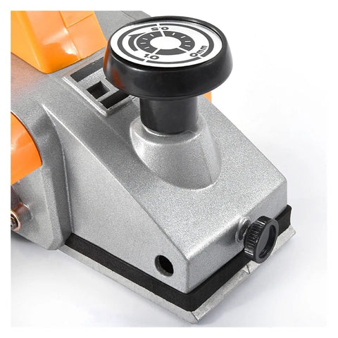 Close-up of Heavy Duty Electric Wood Planer Pumping Out 980 Watts At 23000 Rpm showing depth adjustment knob and tough aluminum base.
